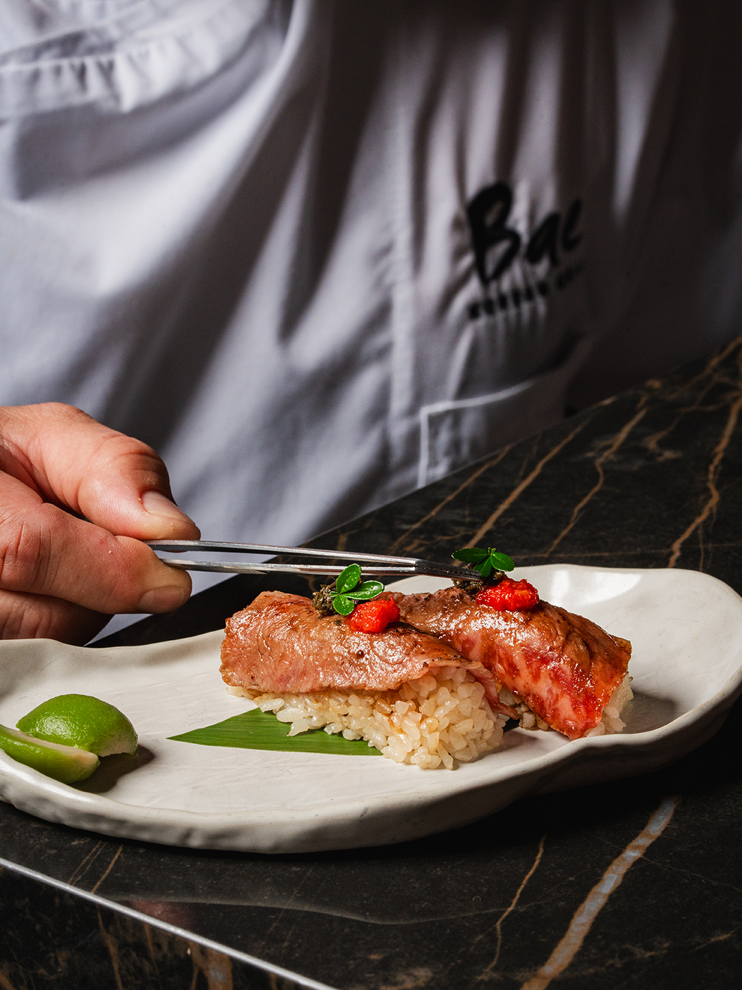 chef holding plate with food