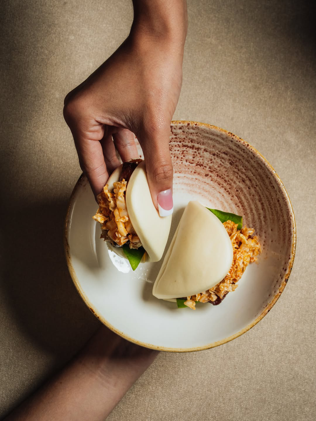 hands holding a plate and food